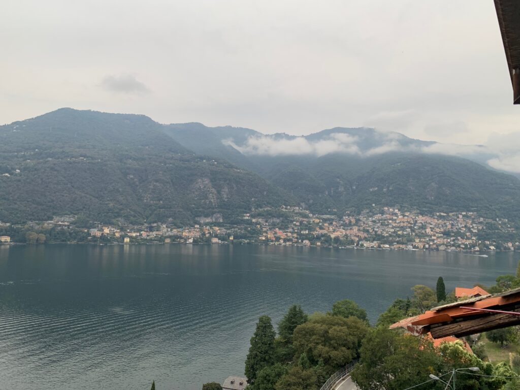 a body of water with a city and mountains in the background