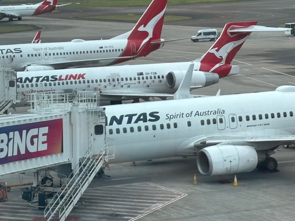 a group of airplanes parked on a runway