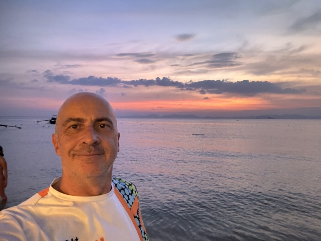 a man taking a selfie at the beach