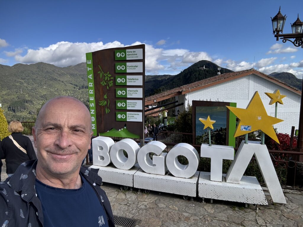 a man taking a selfie in front of a sign