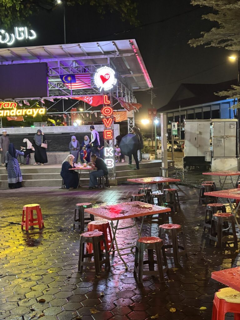 a group of people sitting at tables outside a building