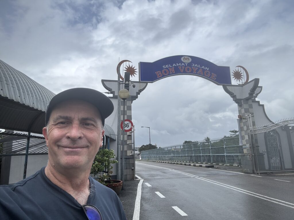 a man taking a selfie in front of a sign