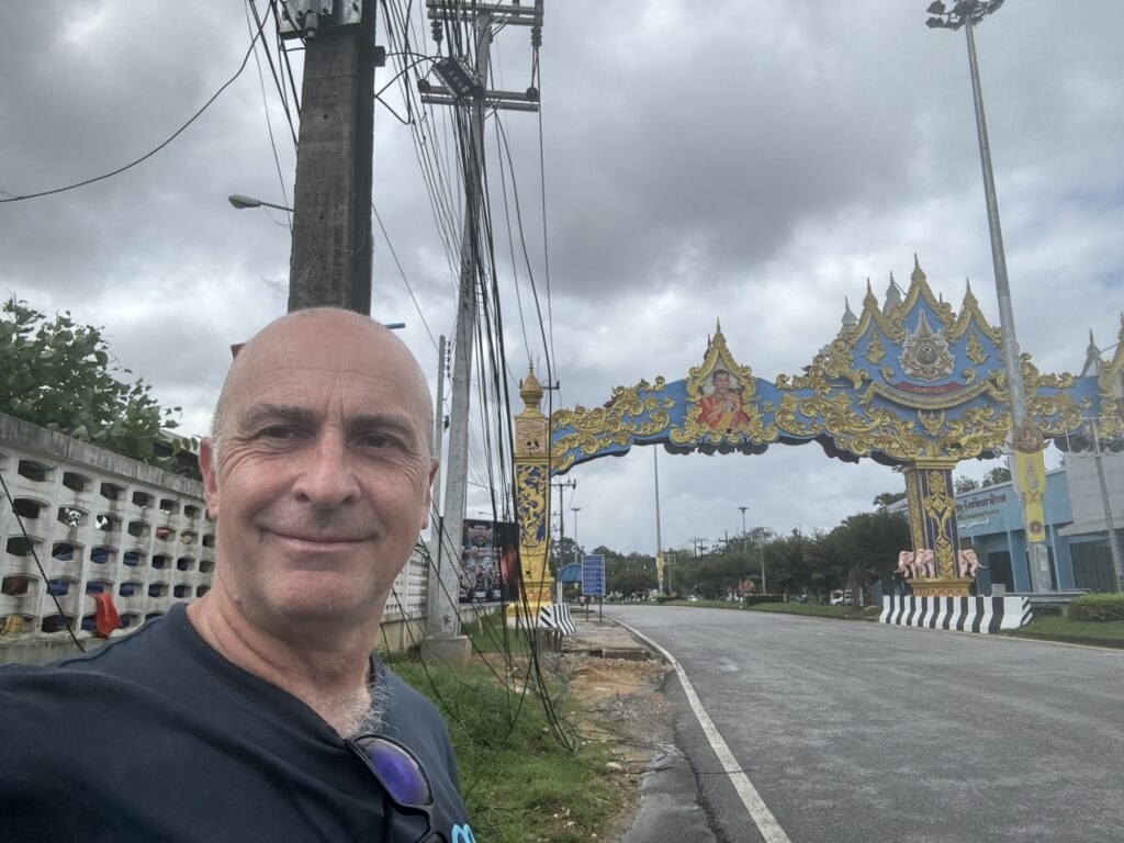 a man taking a selfie in front of a blue and gold archway