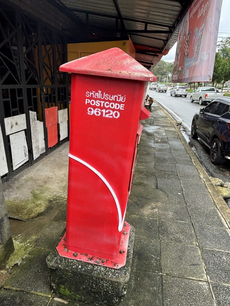 a red post box on the sidewalk