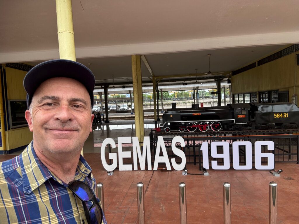 a man taking a selfie in front of a train