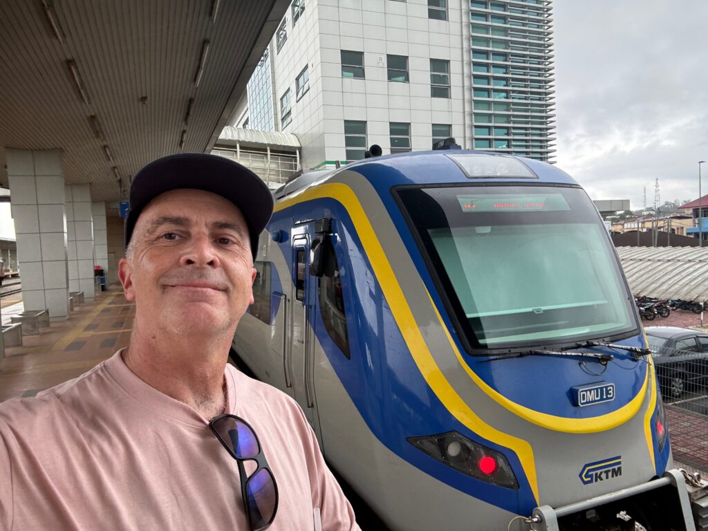 a man standing in front of a train