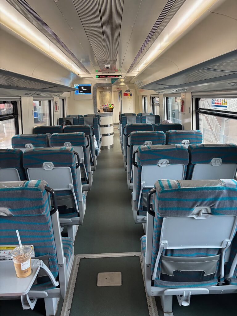 a train with seats and a drink