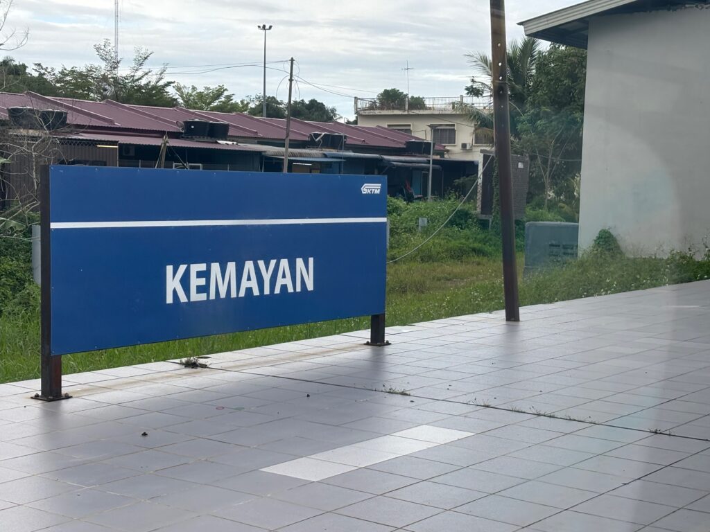 a blue sign on a sidewalk