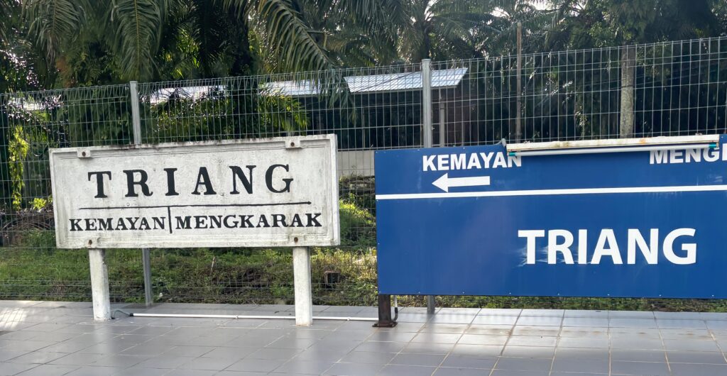 a blue sign next to a fence