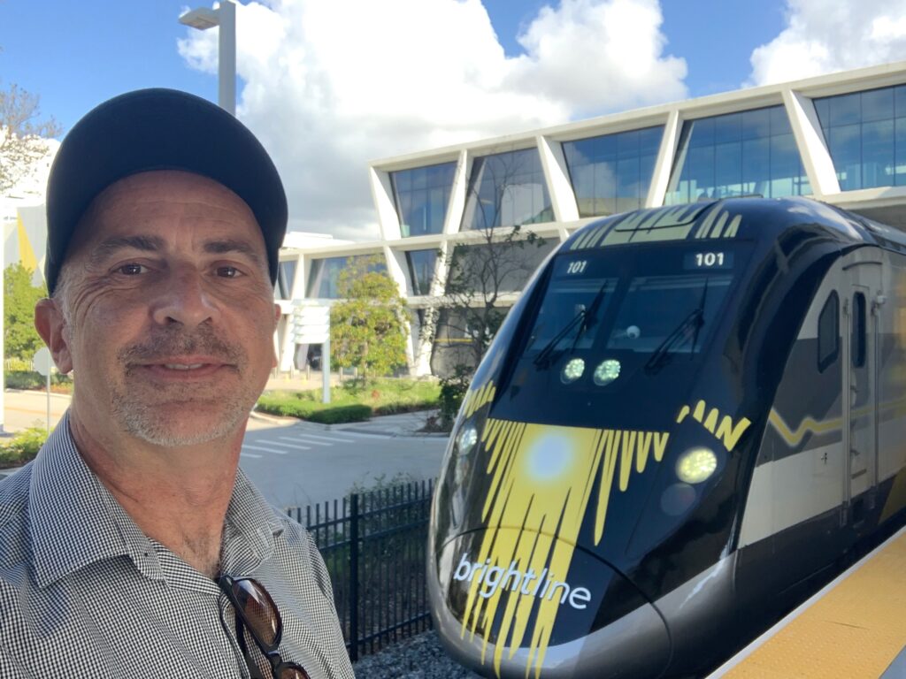 a man taking a selfie with a train