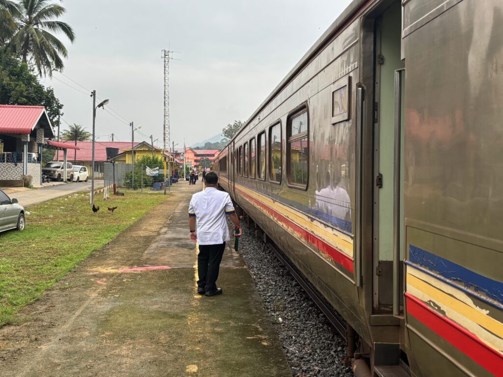 a man standing next to a train