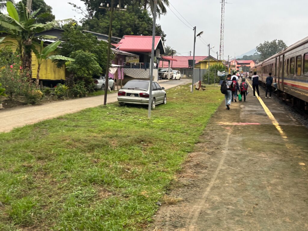 a group of people walking on a train platform