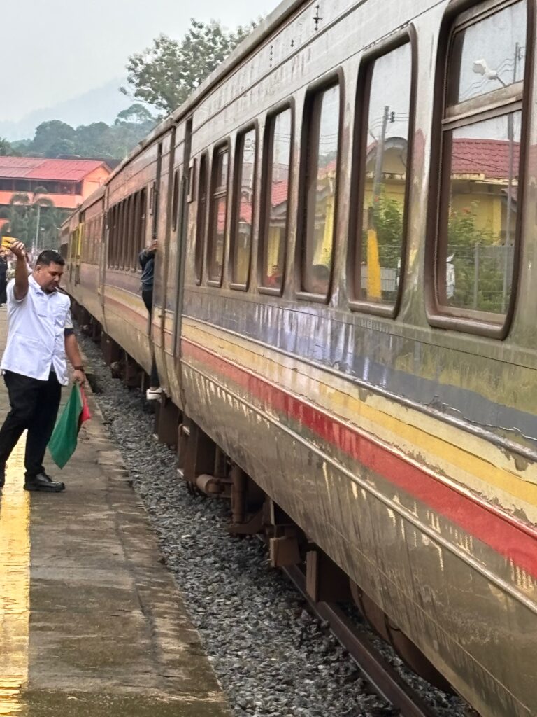 a man standing next to a train