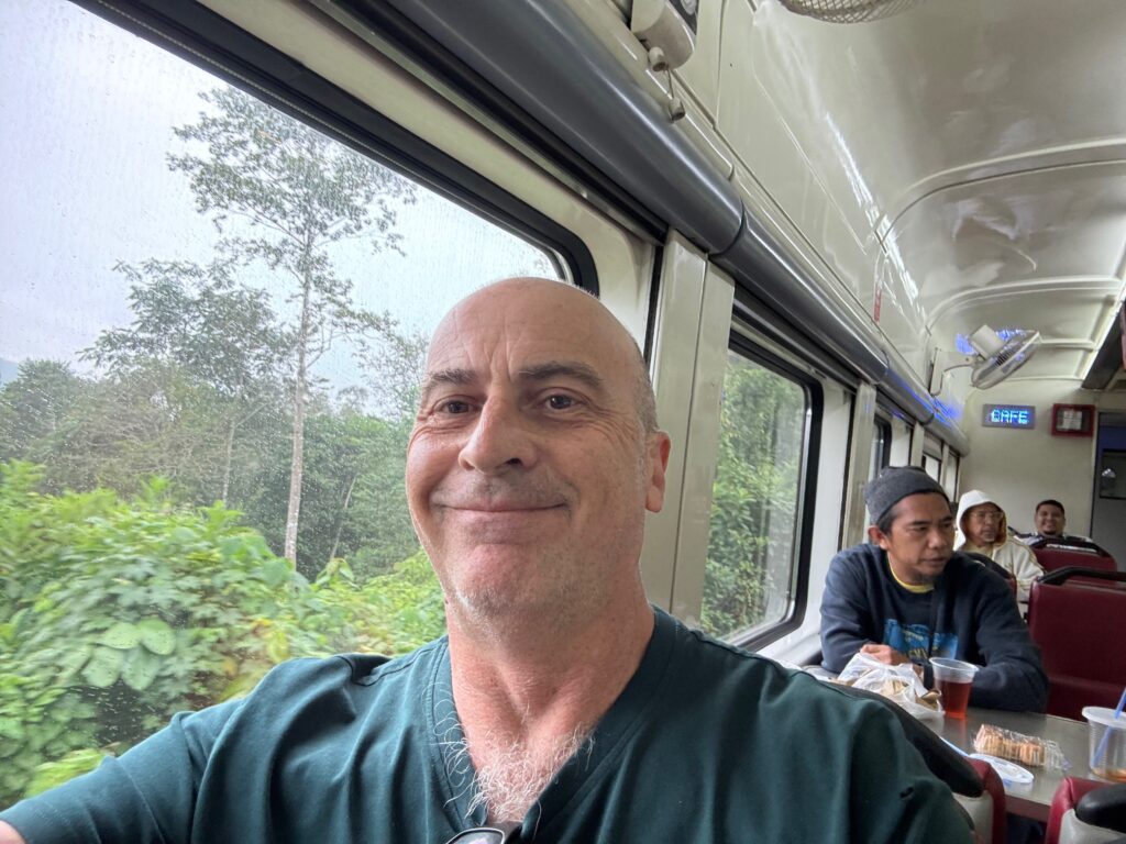 a man smiling in a train