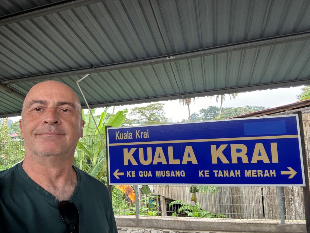 a man standing in front of a sign