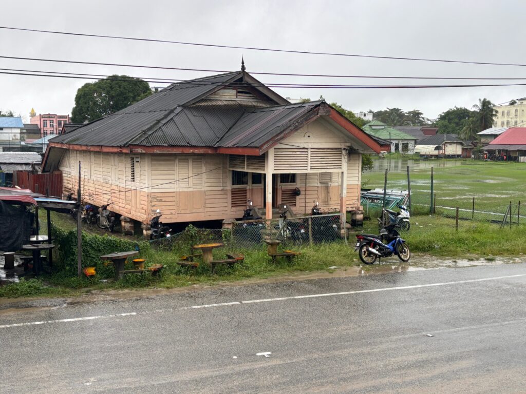 a house with a fence and grass by it