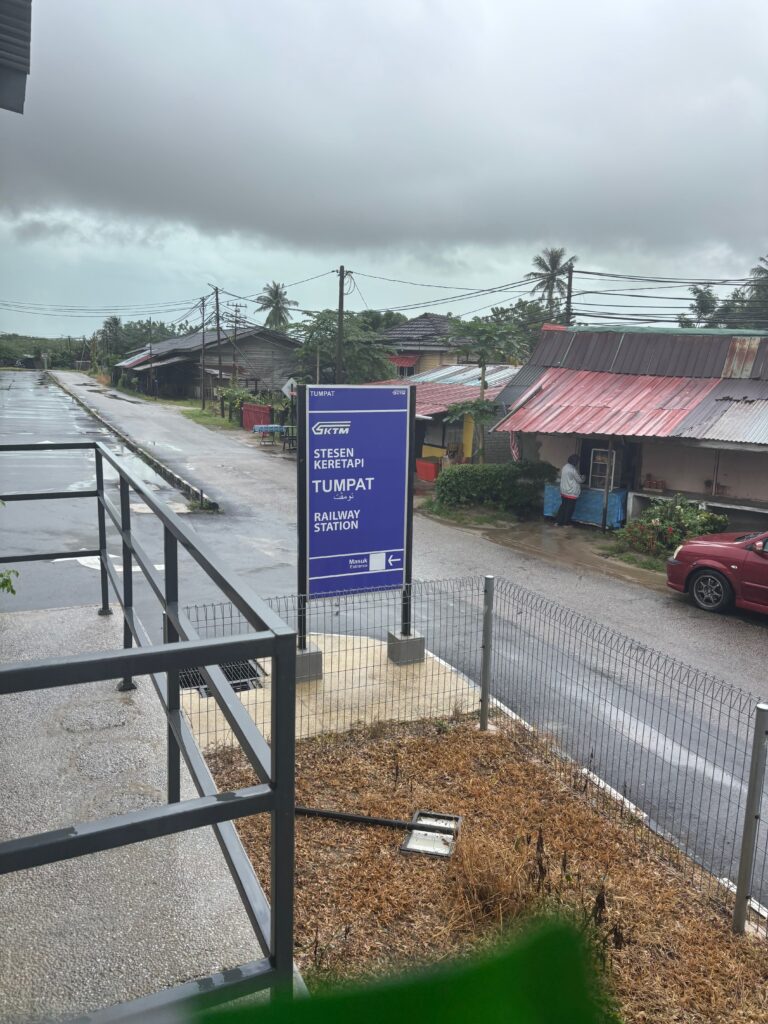 a street with a sign and a fence