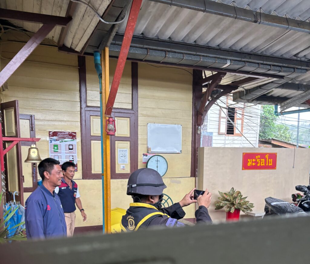 a man in a helmet taking a picture of another man in a building