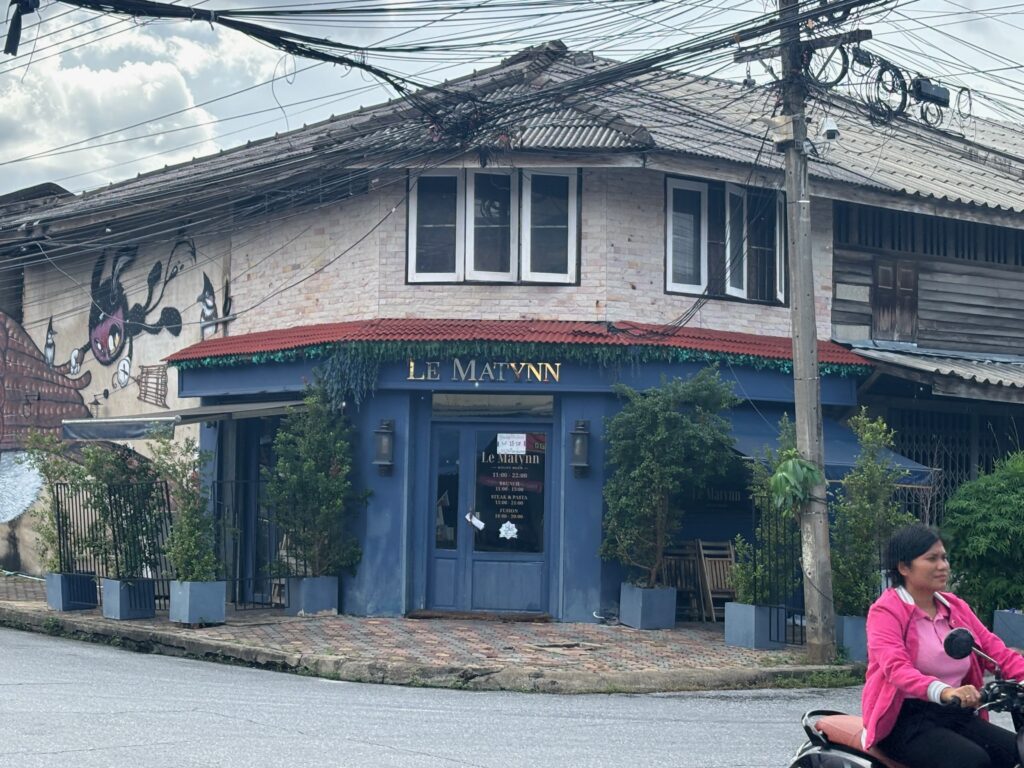 a building with a blue door and a red roof