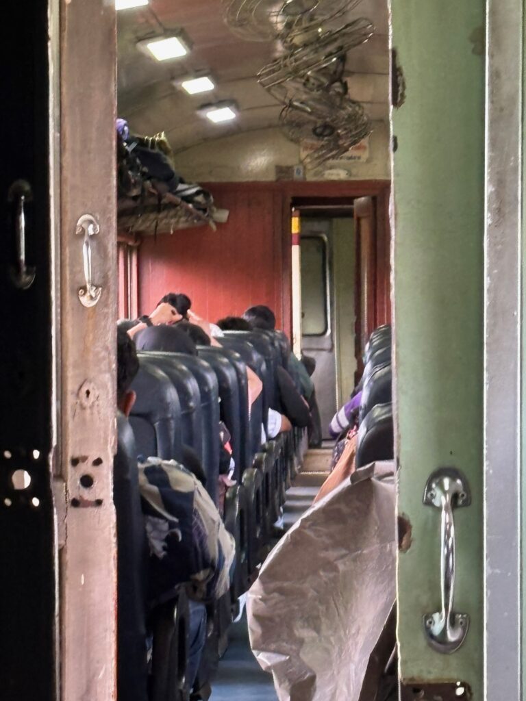 a group of people sitting in a train