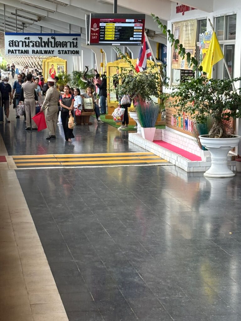 a group of people walking in a train station