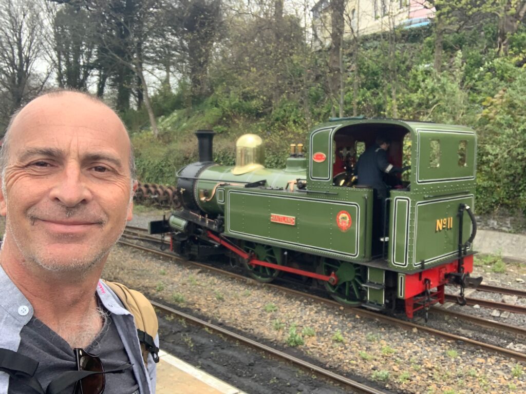 a man taking a selfie with a train