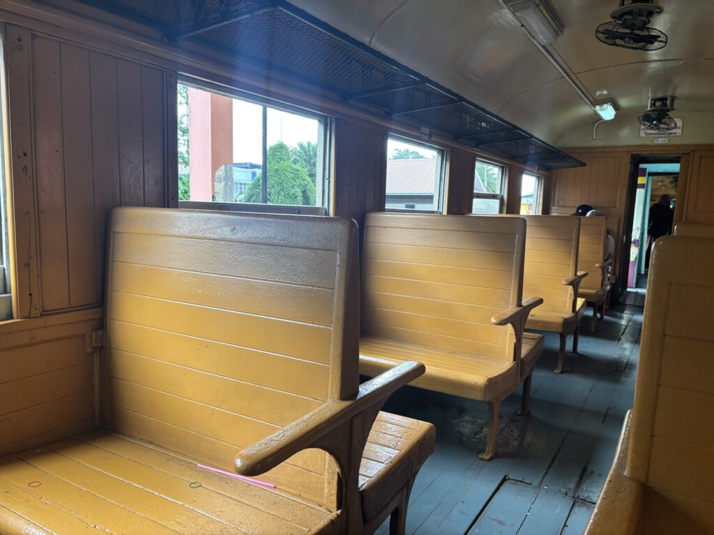 a row of wooden benches in a train