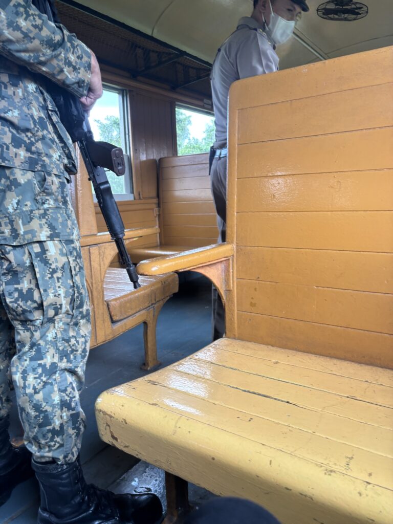 a couple of men in military uniforms standing in a train