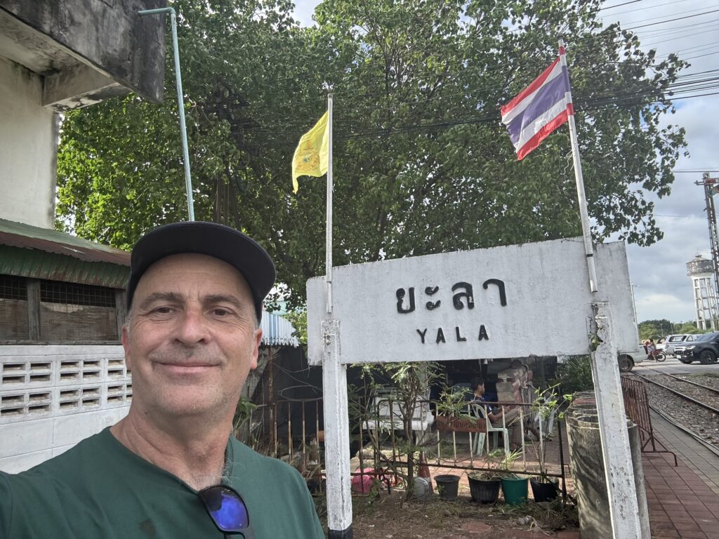 a man standing in front of a sign