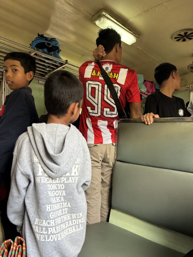 a group of boys standing in a train