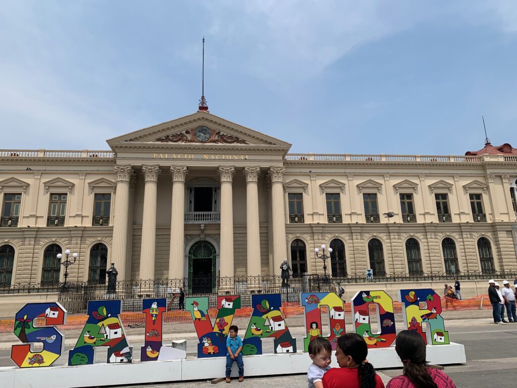 a group of people standing in front of a large building