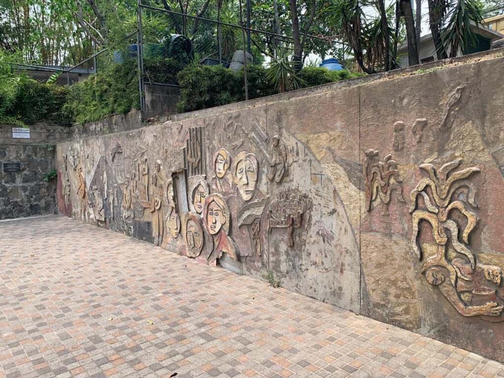 a wall with carved faces on it