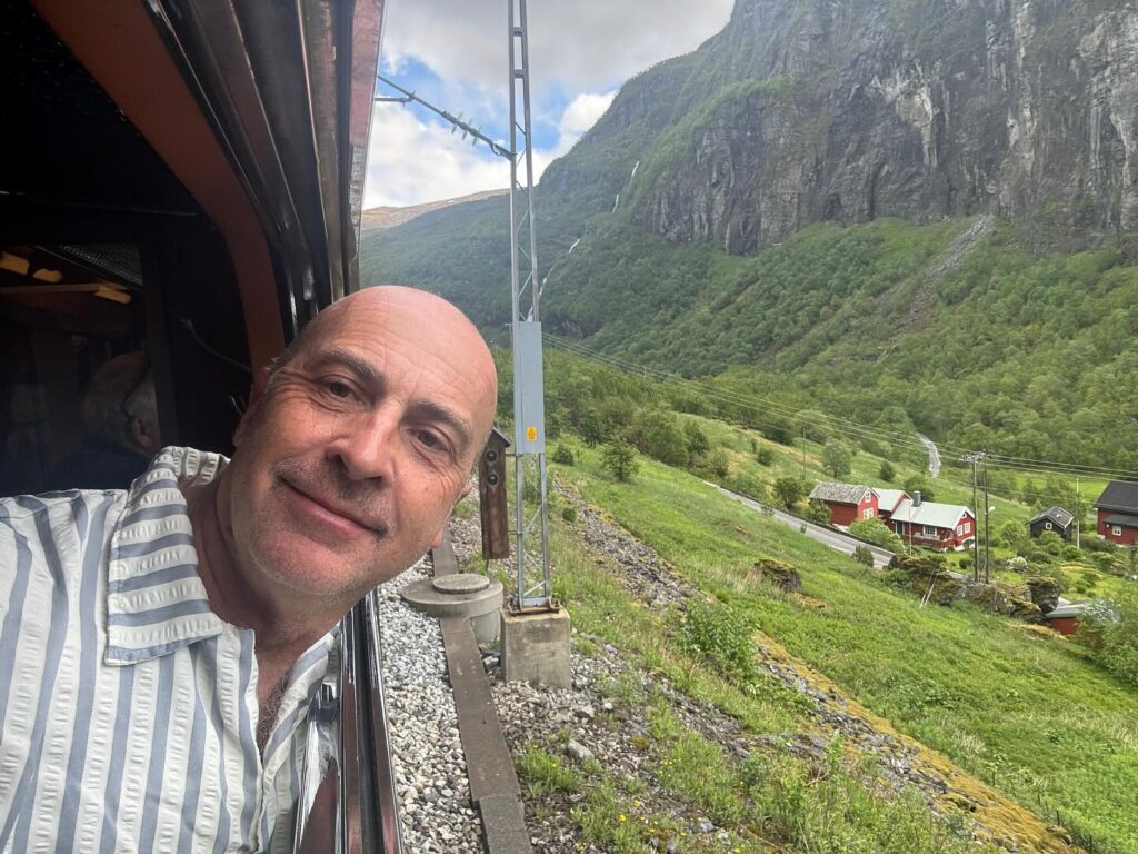 a man looking out a window of a train