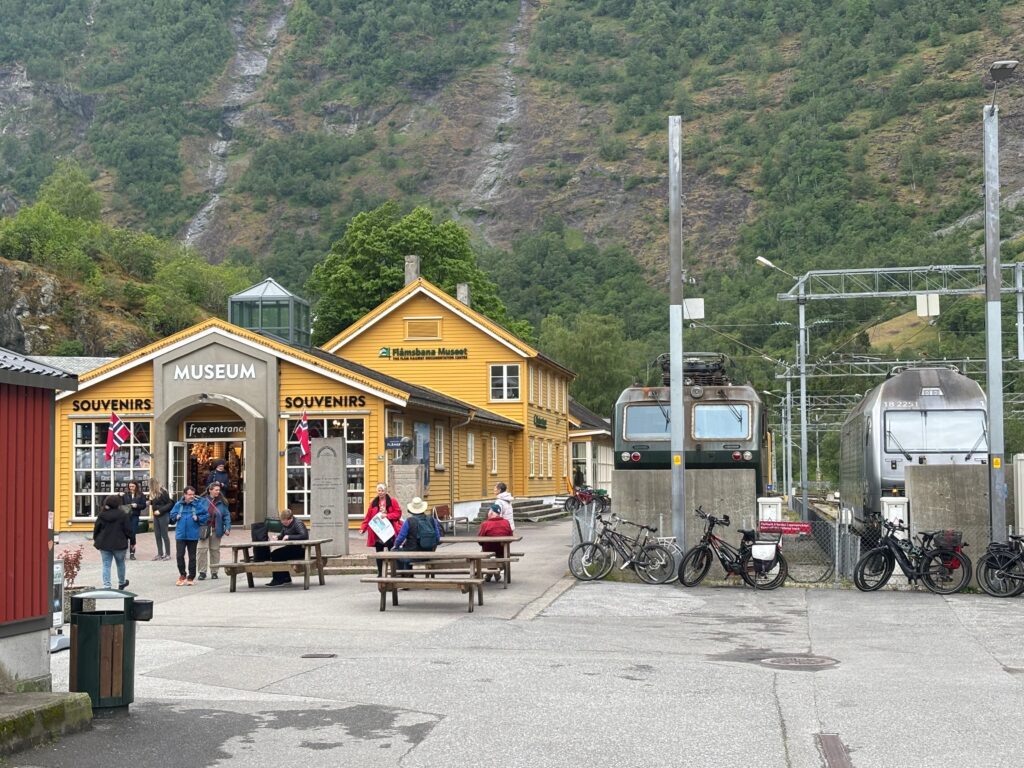 a train station with people and bicycles