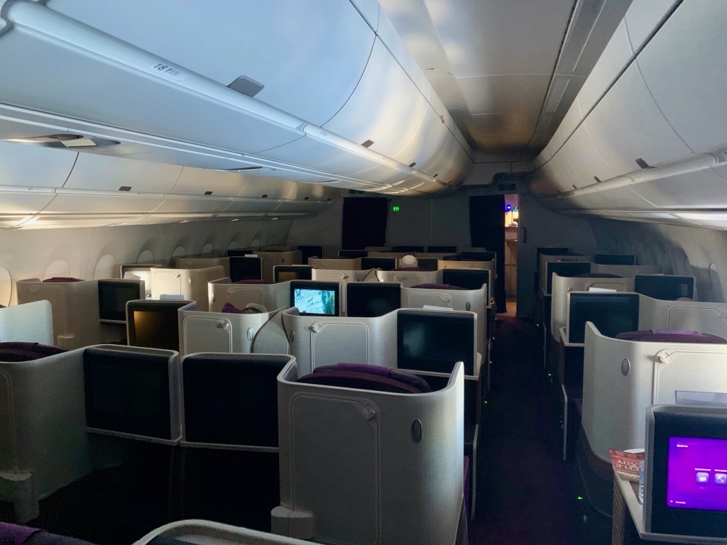 a row of seats with monitors on the side