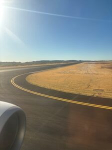 a road with a curved road and a field