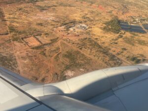 an airplane wing and a landscape