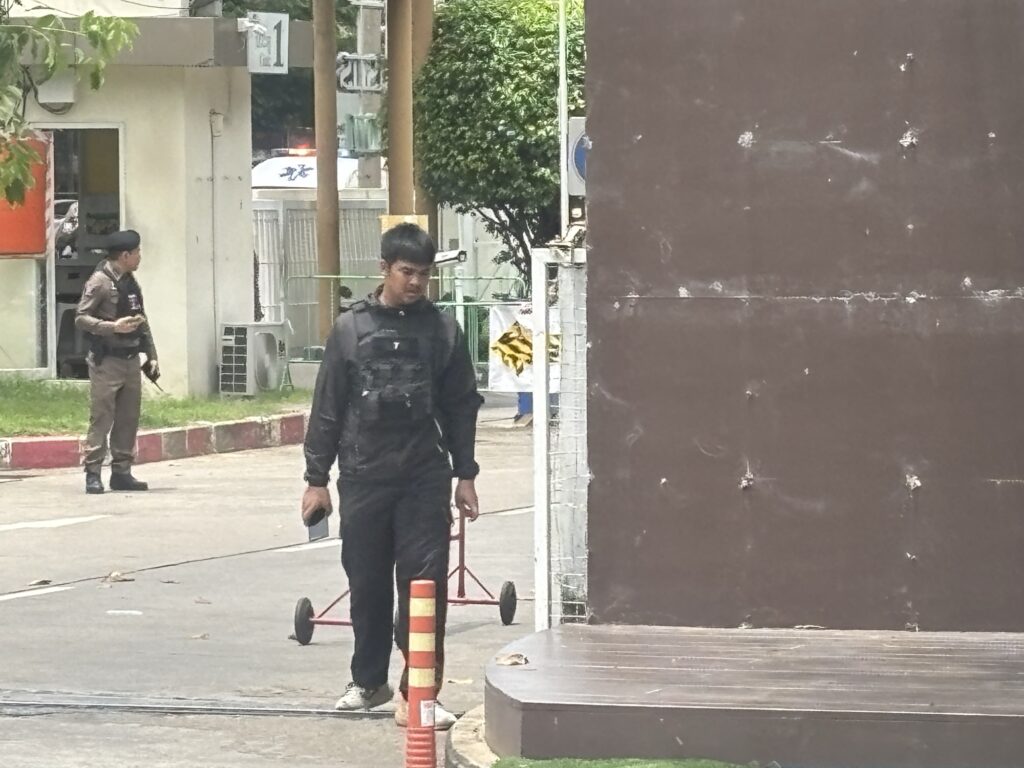 a man in black uniform standing on a street corner