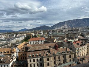 a city with many buildings and mountains in the background