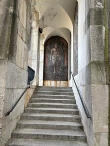 a stone staircase with a mural on the wall
