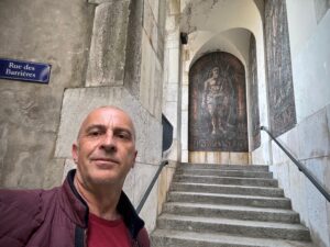 a man taking a selfie in front of a stone building