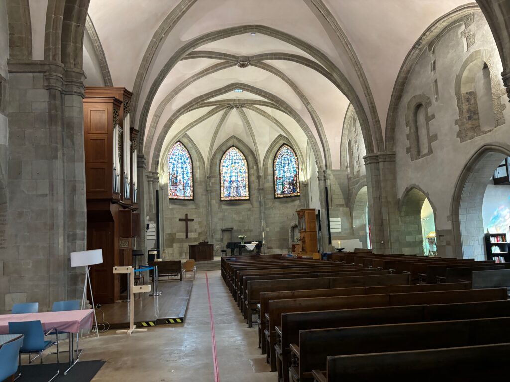 a church with pews and stained glass windows
