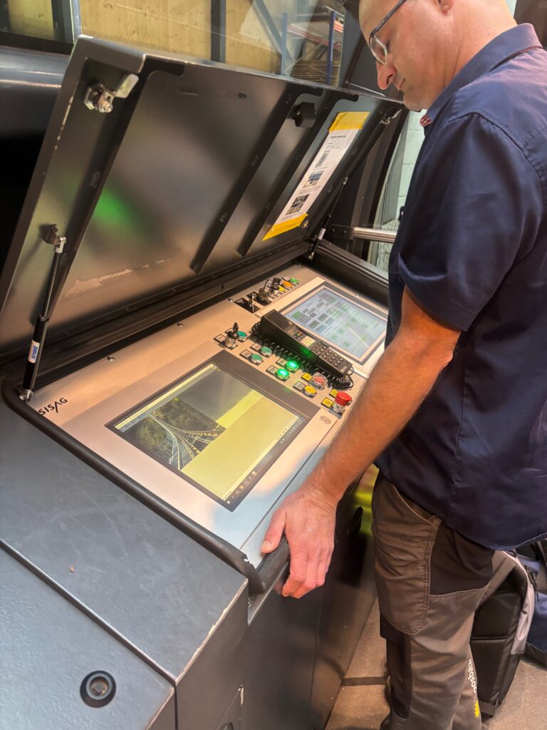 a man standing next to a machine