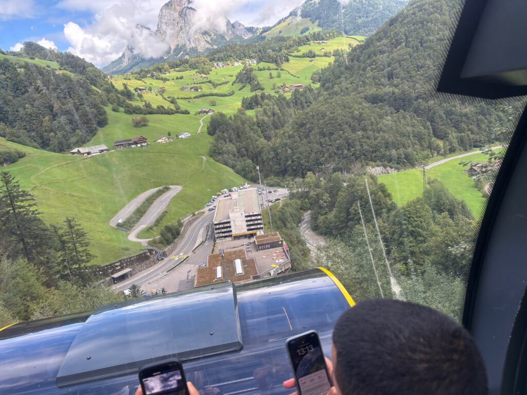 a group of people looking at a cable car