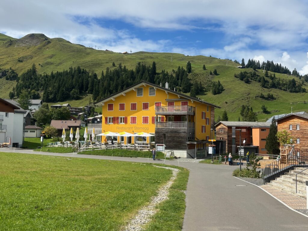 a yellow building with trees in the background