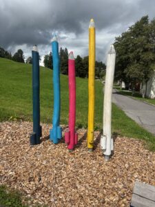 a group of colored pencils in a park