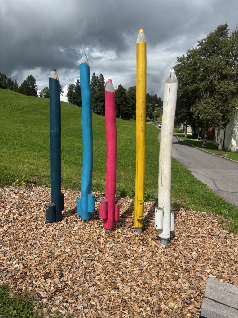 a group of colored pencils in a park