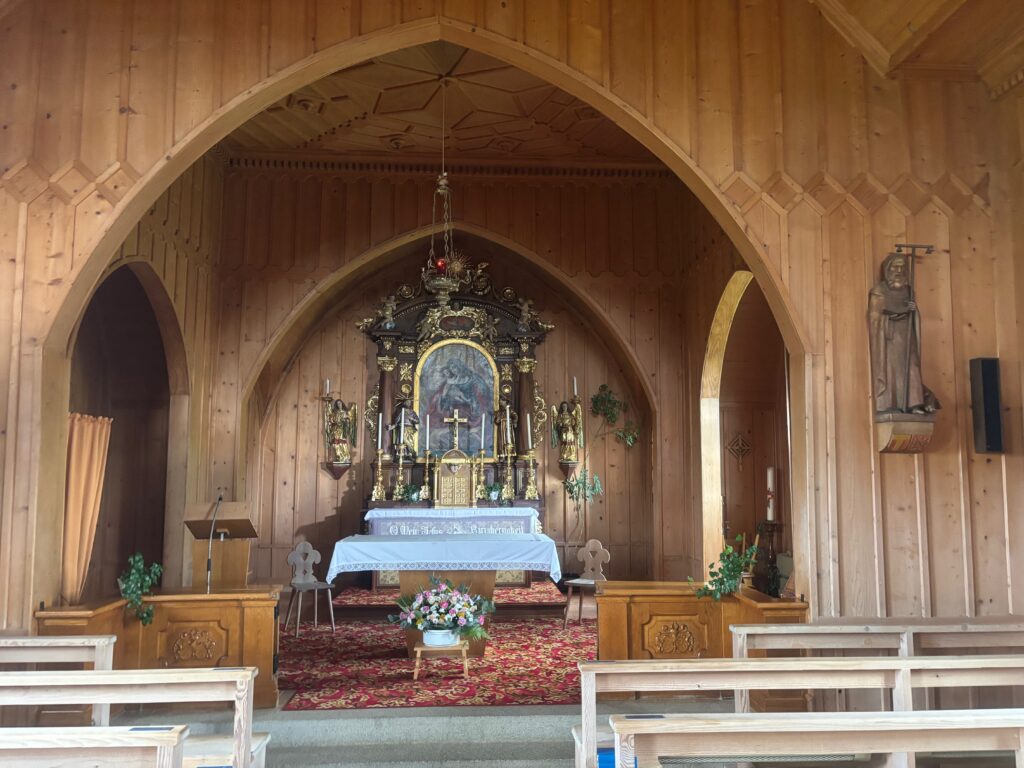 a wooden church with a altar and benches