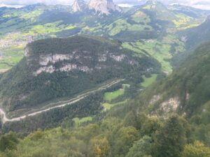 a landscape of a valley with trees and mountains