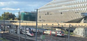 trains on tracks next to a building